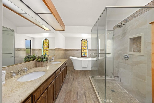 1824 S Marengo Ave Unit 27, Alhambra, CA 91803 - full bath with tile walls, a stall shower, wood finished floors, a freestanding bath, and wainscoting