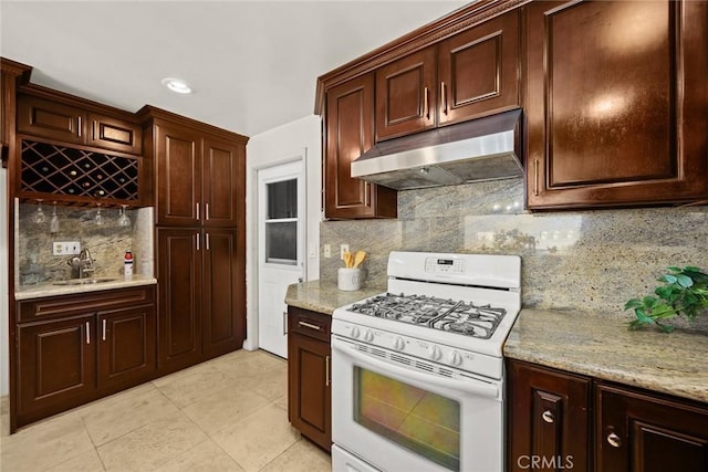 1824 S Marengo Ave Unit 27, Alhambra, CA 91803 - kitchen featuring white gas range, under cabinet range hood, a sink, decorative backsplash, and light tile patterned floors