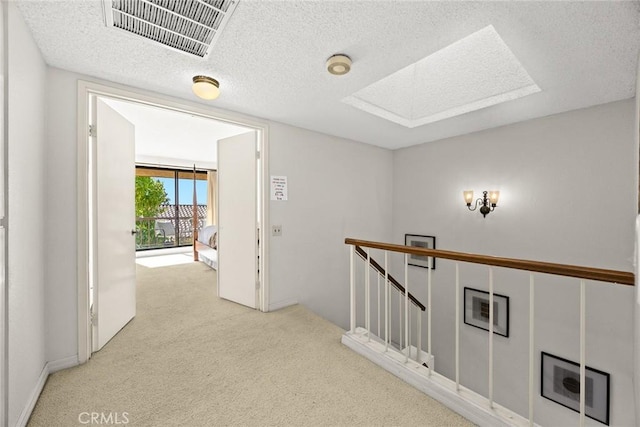1824 S Marengo Ave Unit 27, Alhambra, CA 91803 - hallway with an upstairs landing, a textured ceiling, carpet, and a skylight