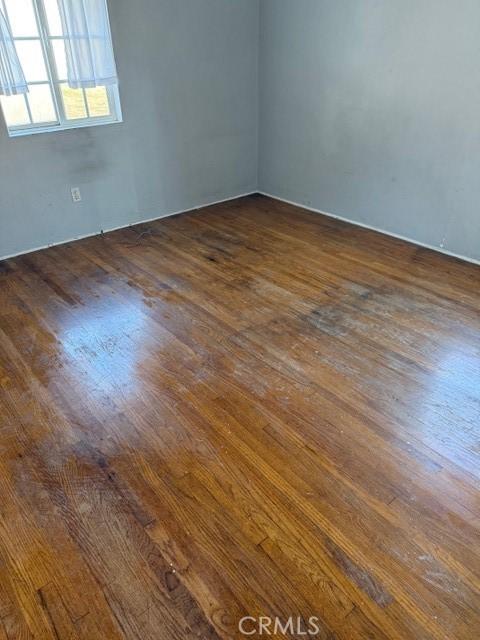 empty room with dark hardwood / wood-style floors