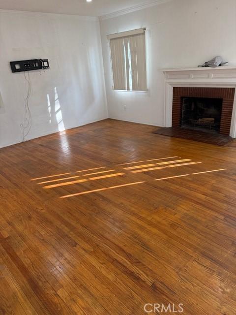 unfurnished living room featuring hardwood / wood-style floors and a fireplace