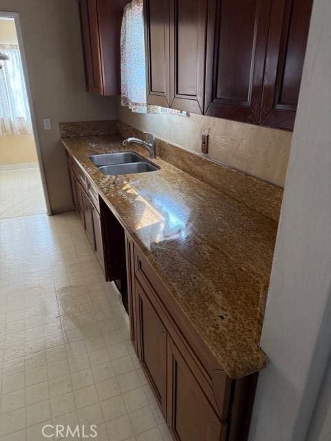 kitchen featuring sink and dark stone counters