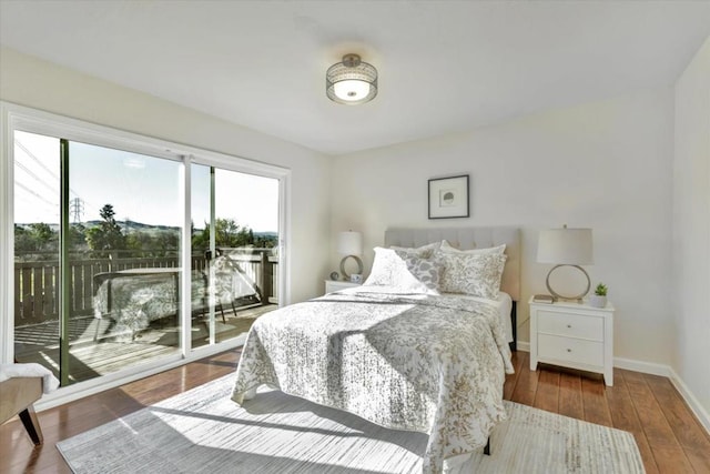 bedroom with hardwood / wood-style flooring and access to outside