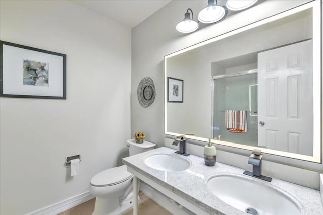 bathroom featuring vanity, an enclosed shower, and toilet