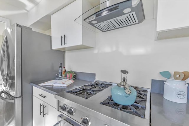 kitchen with white cabinets and wall chimney exhaust hood