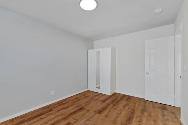 spare room with wood-type flooring