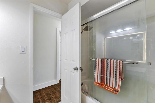 bathroom with bath / shower combo with glass door