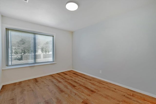 spare room with light hardwood / wood-style flooring