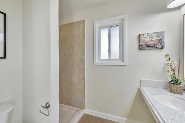 bathroom featuring vanity, a shower, tile patterned floors, and toilet