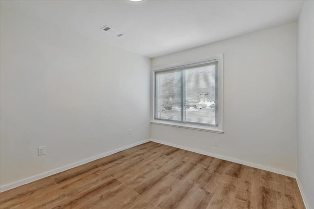 spare room featuring light hardwood / wood-style flooring