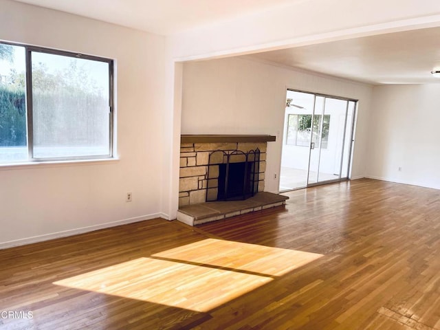 unfurnished living room featuring a fireplace and wood-type flooring