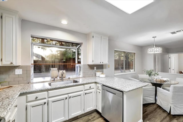 kitchen with sink, stainless steel dishwasher, decorative backsplash, and white cabinets