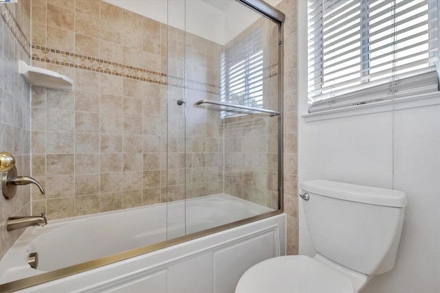 bathroom with enclosed tub / shower combo and toilet