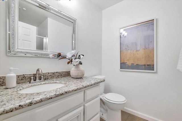 bathroom with vanity, toilet, and tile patterned floors