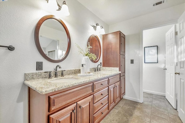 bathroom with tile patterned flooring and vanity