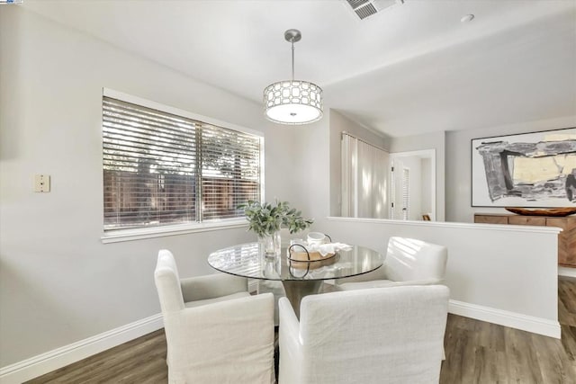 dining space featuring dark hardwood / wood-style flooring