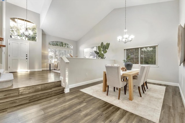 dining area featuring dark hardwood / wood-style floors, high vaulted ceiling, and a notable chandelier