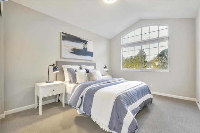 carpeted bedroom with lofted ceiling