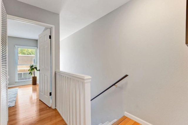 hallway with light hardwood / wood-style floors