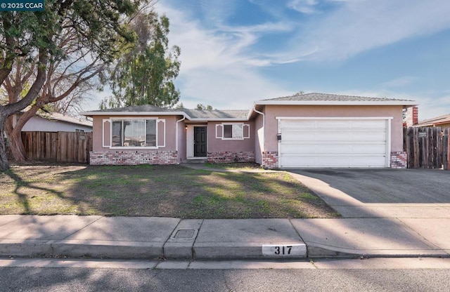 ranch-style house featuring a front yard and a garage