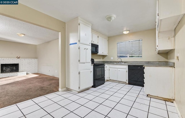 kitchen featuring black appliances, white cabinetry, a fireplace, light carpet, and sink