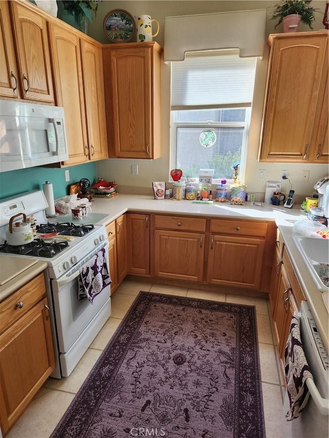 kitchen with white appliances and light tile patterned floors