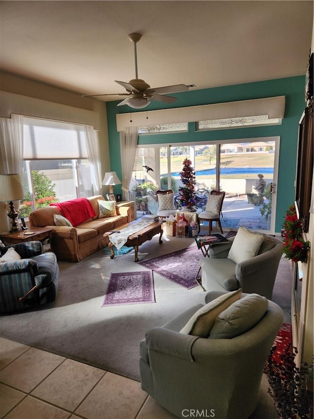 living room with tile patterned floors and ceiling fan