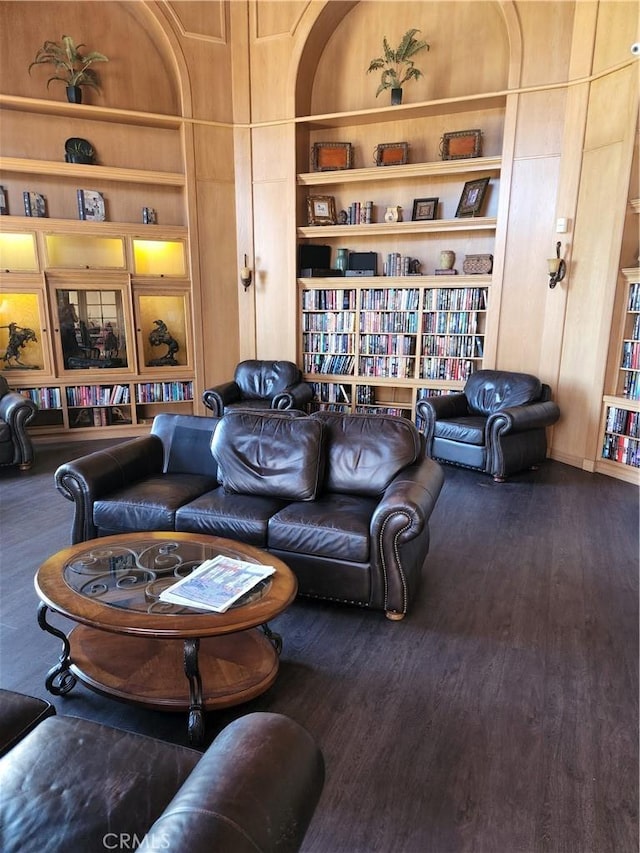 living room with hardwood / wood-style flooring and built in features