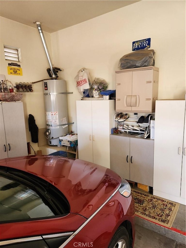 garage featuring washing machine and dryer and water heater