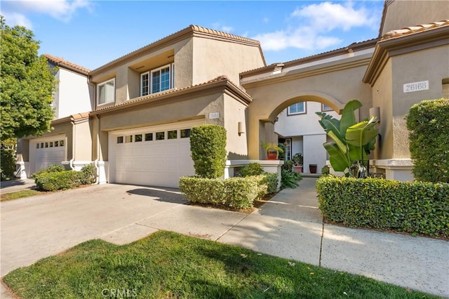 mediterranean / spanish home featuring a garage