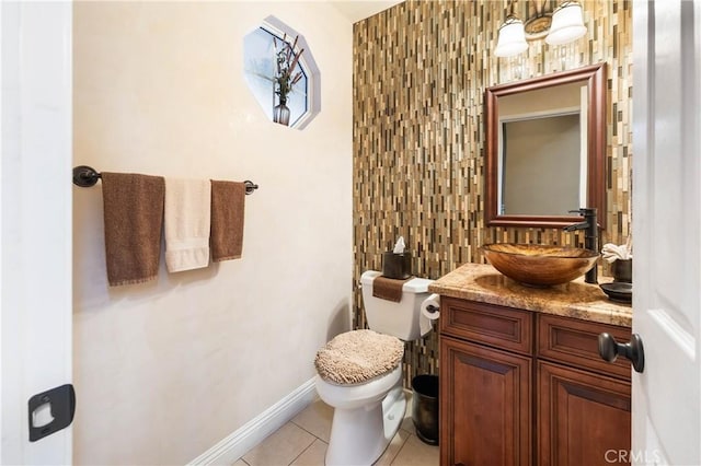 bathroom with toilet, tile patterned floors, decorative backsplash, and vanity