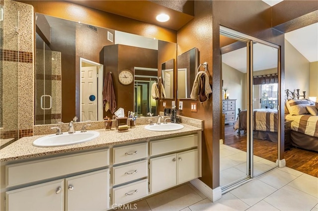 bathroom with vanity, tile patterned floors, and a shower with shower door