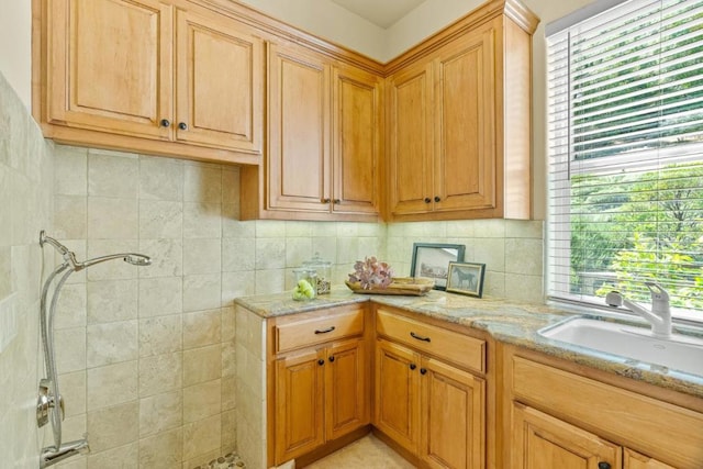 kitchen with sink and light stone countertops