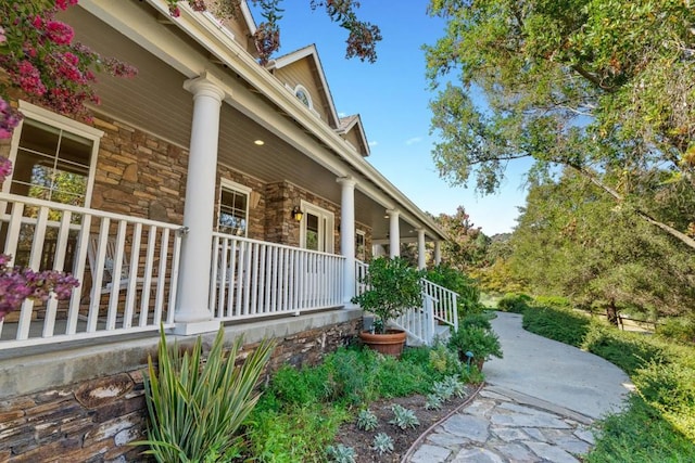 view of side of home with covered porch