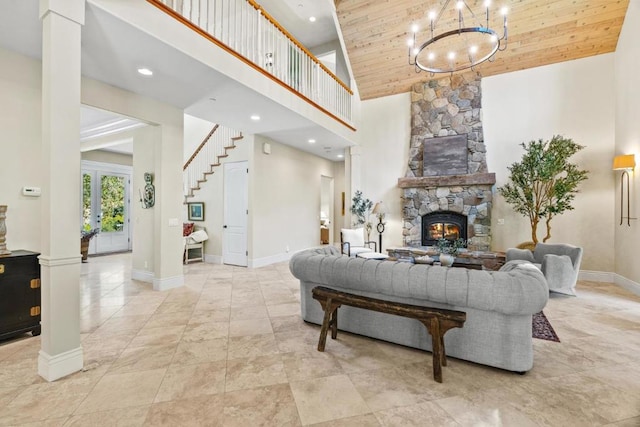 living room with ornate columns, high vaulted ceiling, wooden ceiling, and a stone fireplace