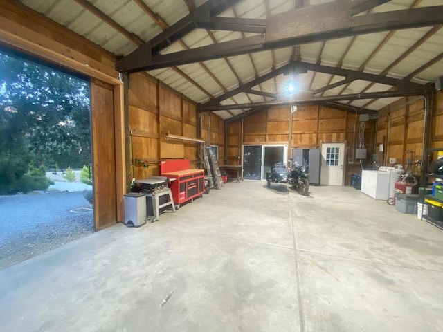 garage featuring washer / dryer and wood walls