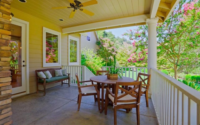 view of patio with ceiling fan and a balcony