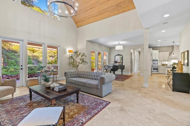 living room featuring high vaulted ceiling, wooden ceiling, french doors, and a notable chandelier