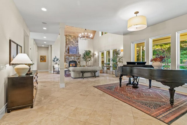 misc room featuring an inviting chandelier and a stone fireplace