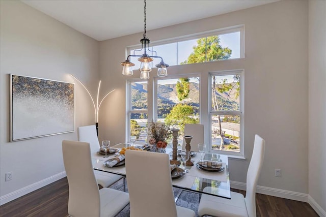 dining area featuring dark hardwood / wood-style floors and a chandelier