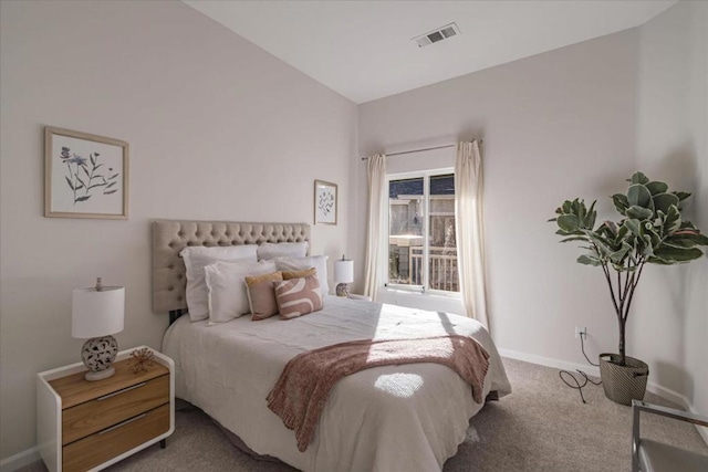 bedroom with vaulted ceiling and carpet floors