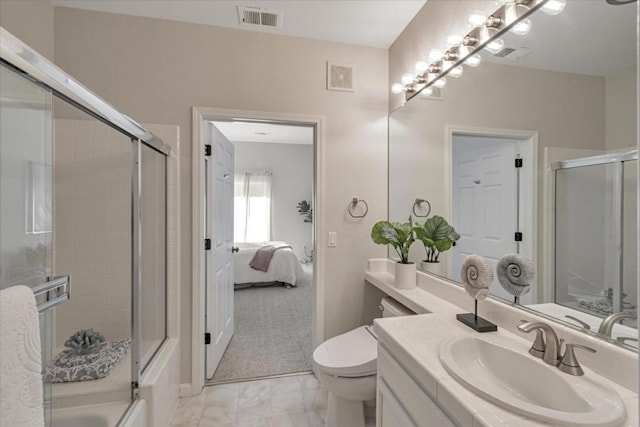 full bathroom with vanity, combined bath / shower with glass door, and toilet