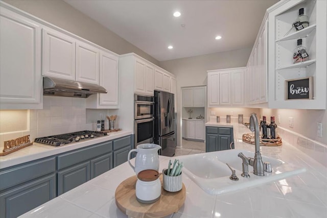 kitchen featuring stainless steel appliances, white cabinetry, sink, and gray cabinetry