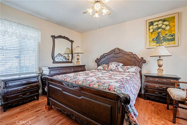 bedroom with ceiling fan and light hardwood / wood-style floors