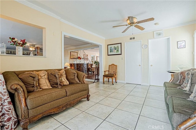 tiled living room with ceiling fan and crown molding