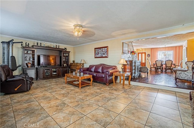 living room featuring a textured ceiling, ceiling fan, and crown molding