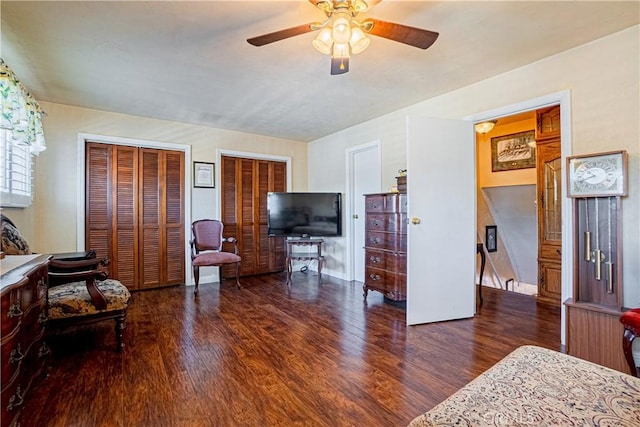 living room featuring ceiling fan and dark hardwood / wood-style flooring