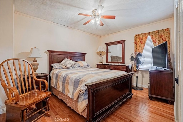 bedroom featuring a textured ceiling, ceiling fan, crown molding, and light hardwood / wood-style floors