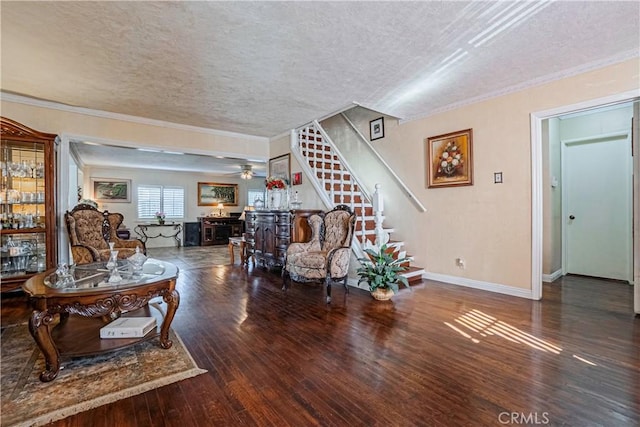 living room with a textured ceiling, ceiling fan, ornamental molding, and dark wood-type flooring