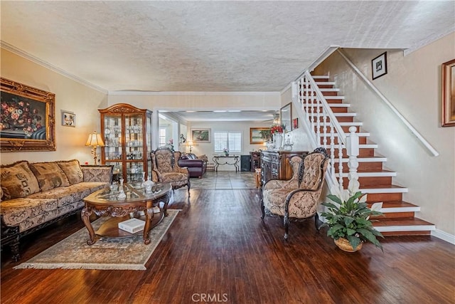 living room featuring a textured ceiling, hardwood / wood-style floors, and crown molding